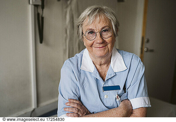 Portrait of senior female medical expert with arms crossed