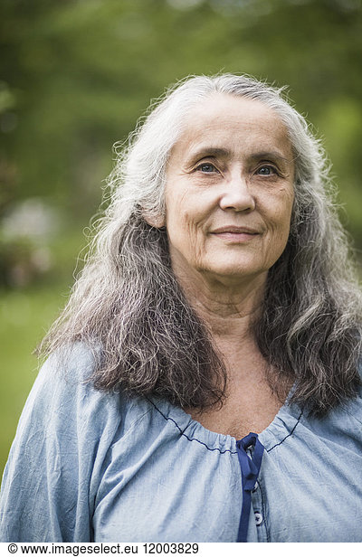 Portrait of senior woman standing in back yard
