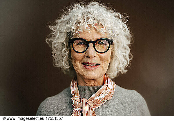 Portrait of senior woman wearing eyeglasses in studio
