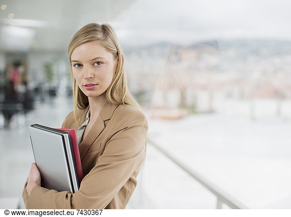 Portrait of serious businesswoman at window