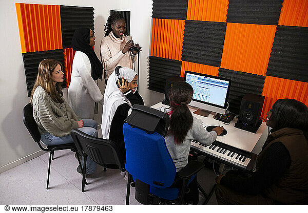 Portrait of singers and composers working in recording studio