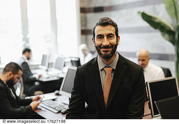 Portrait of smiling bearded male financial advisor in law office