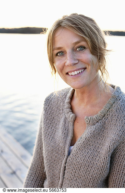 Portrait of smiling blond mid adult woman outdoors