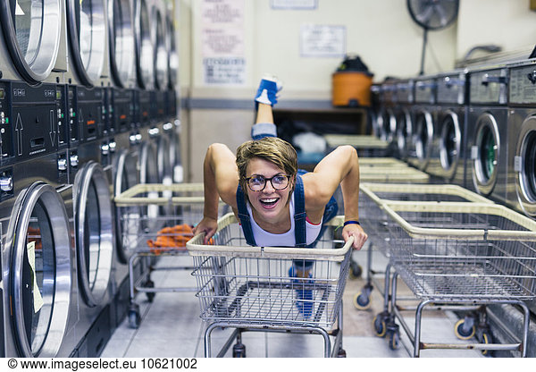 Portrait of smiling blond woman in a laundry