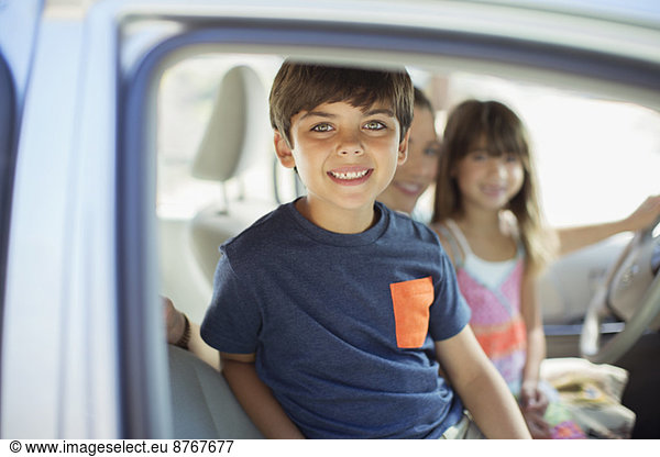 Portrait of smiling boy inside car