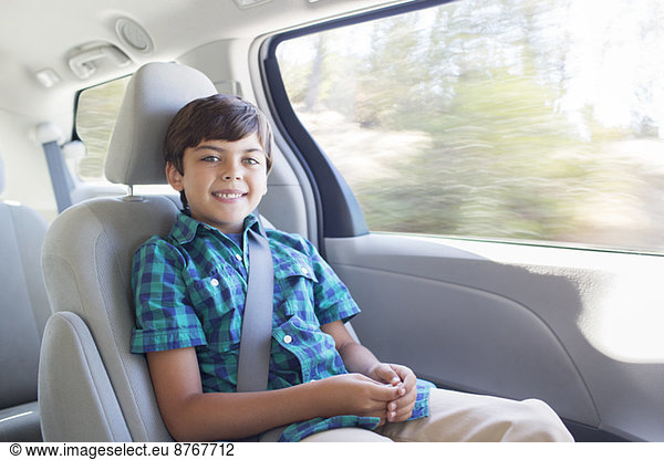 Portrait of smiling boy inside car