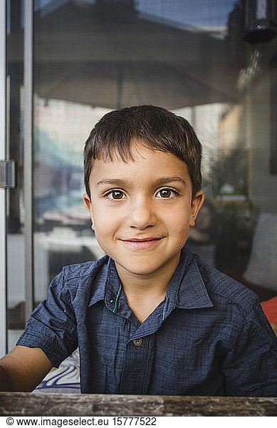 Portrait of smiling boy sitting at table