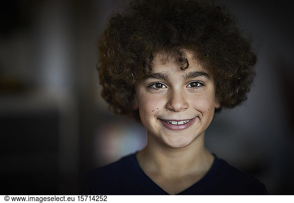 Portrait of smiling boy with brown ringlets