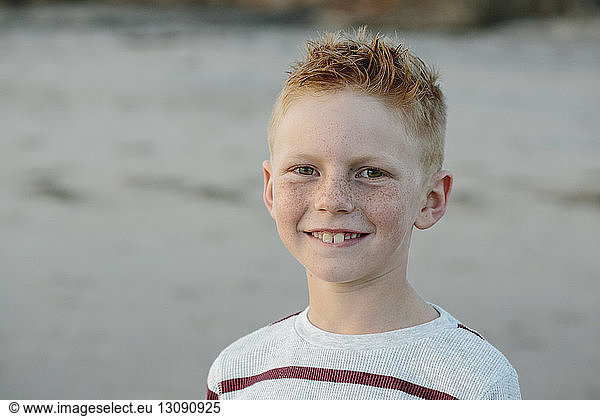 Portrait of smiling boy with freckles at beach
