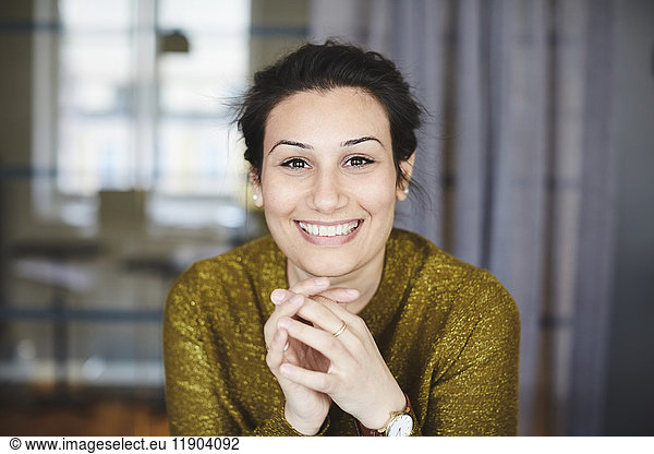 Portrait of smiling businesswoman at creative office