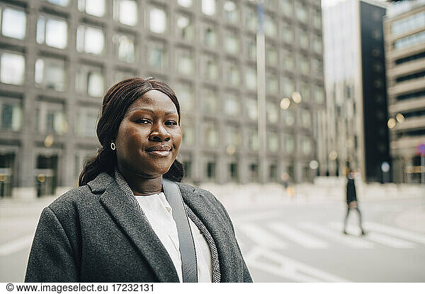 Portrait of smiling businesswoman in city