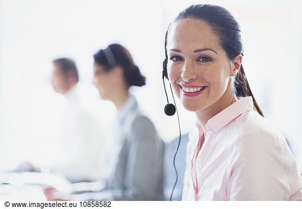 Portrait of smiling businesswoman talking on the phone with headset