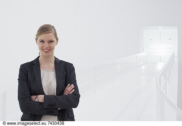 Portrait of smiling businesswoman with arms crossed