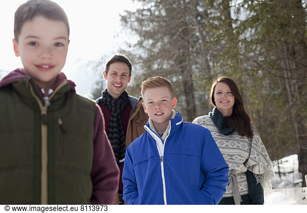 Portrait of smiling family in snowy woods