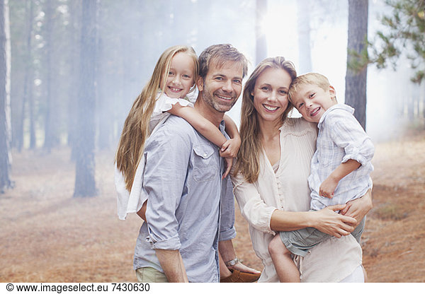 Portrait of smiling family in woods