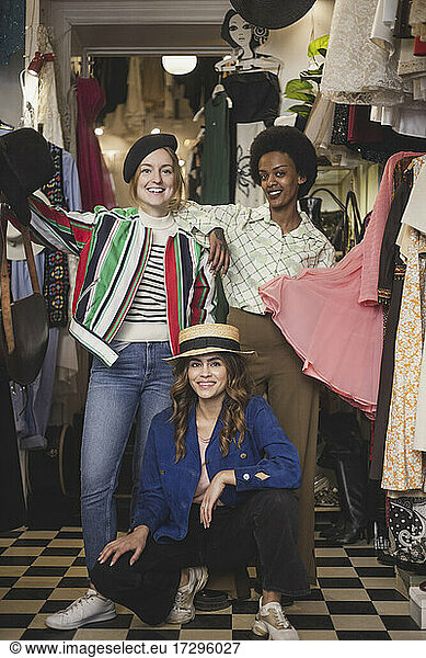 Portrait of smiling female colleagues in clothing store