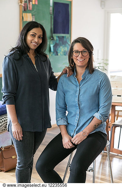 Portrait of smiling female design professionals in home office