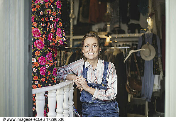 Portrait of smiling female employee at clothing store