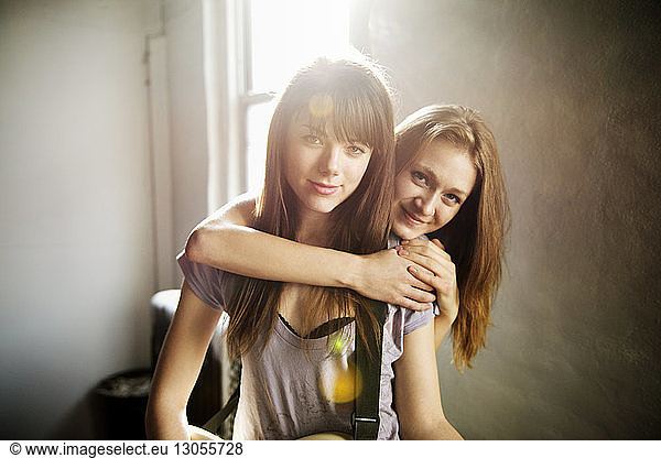 Portrait of smiling female friends at home