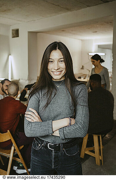 Portrait of smiling female hacker in startup company