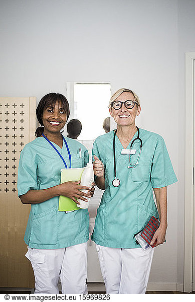 Portrait of smiling female healthcare workers standing in clinic