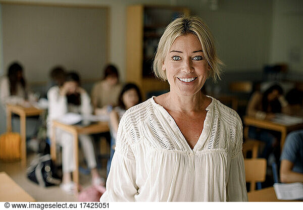 Portrait of smiling female teacher in classroom