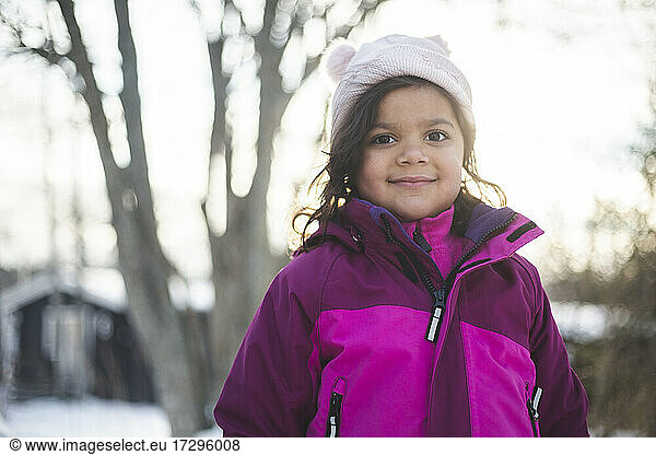 Portrait of smiling girl wearing warm clothing during winter