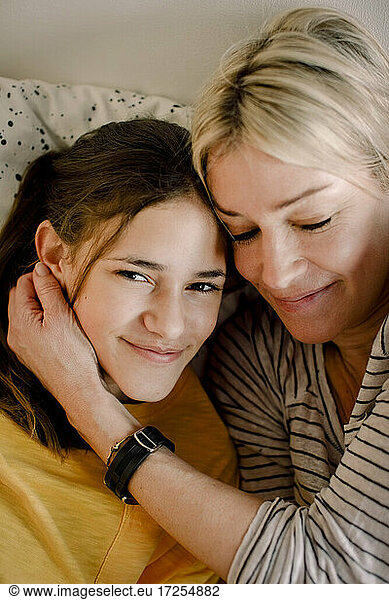 Portrait of smiling girl with blond mother