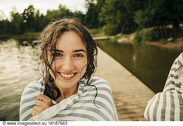 Portrait of smiling girl wrapped in towel during vacation