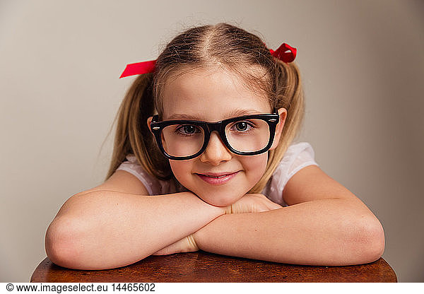 Portrait of smiling ittle girl wearing oversized glasses