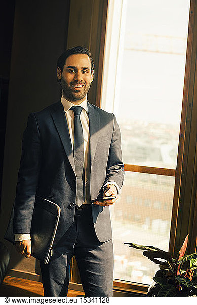 Portrait of smiling lawyer standing in office