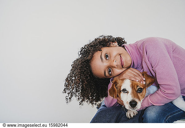 Portrait of smiling little girl and her dog