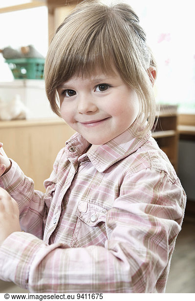 Portrait of smiling little girl in kindergarten