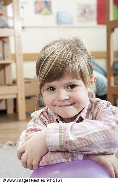 Portrait of smiling little girl with crossed arms