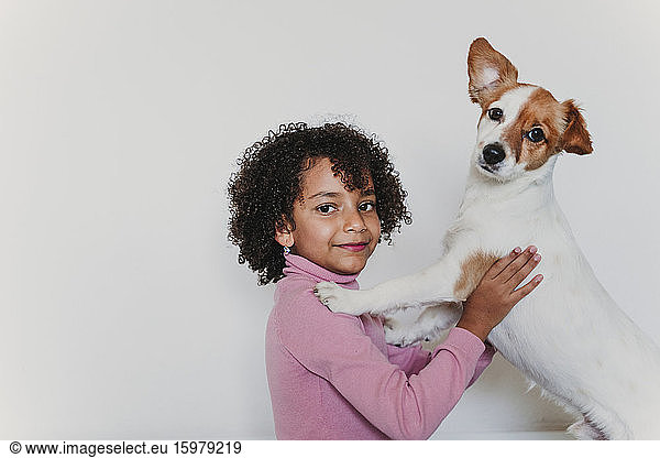 Portrait of smiling little girl with her dog