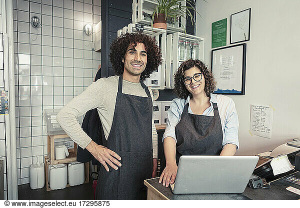 Portrait of smiling male and female owners at organic store