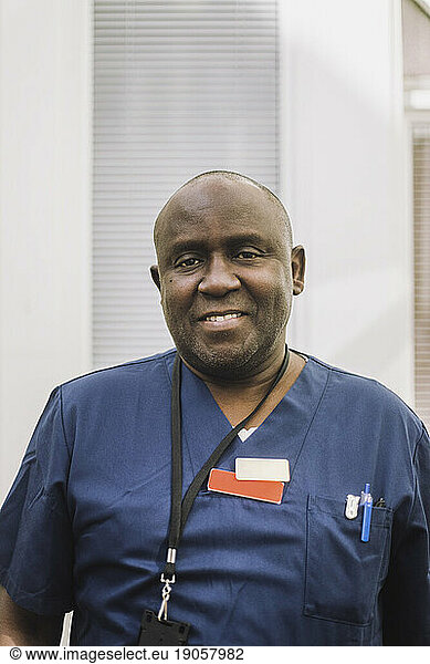 Portrait of smiling male doctor at healthcare center