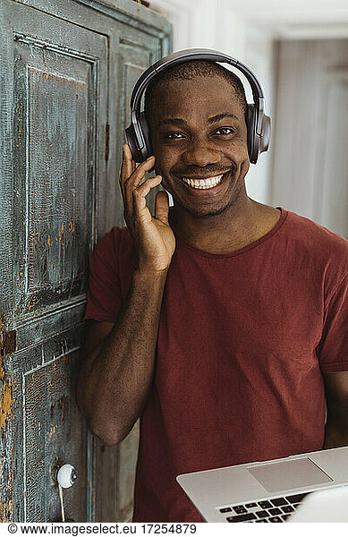Portrait of smiling male professional with headphones at home