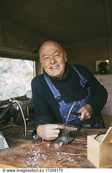 Portrait of smiling male welder at workshop