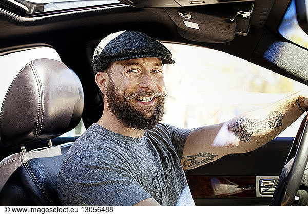 Portrait of smiling man sitting in car