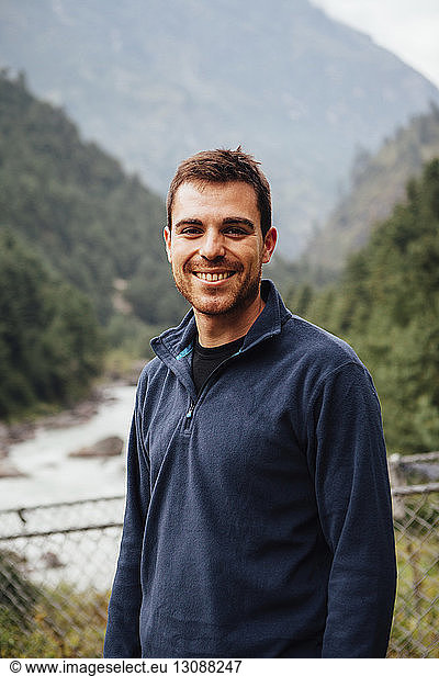 Portrait of smiling man standing against mountains at Sagarmatha National Park