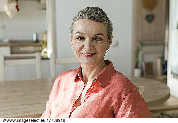 Portrait of smiling mature woman at home