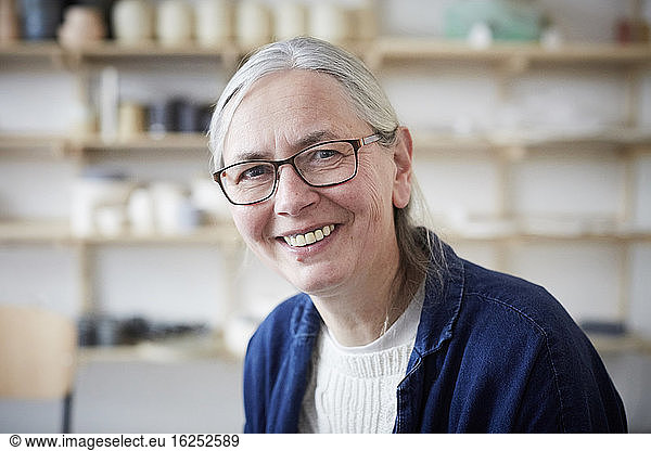 Portrait of smiling mature woman in art class