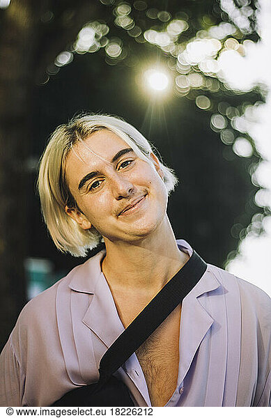 Portrait of smiling non-binary person with blond hair