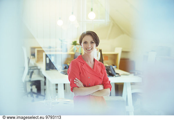 Portrait of smiling office worker with crossed hands