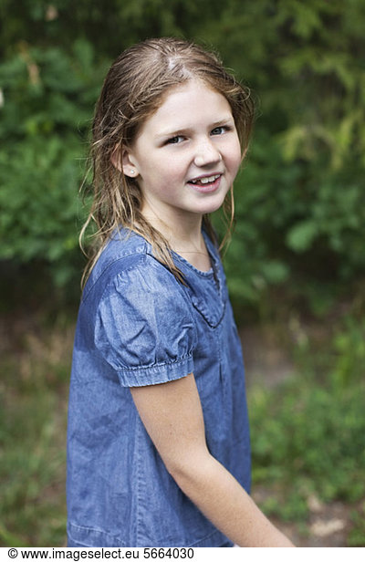 Portrait of smiling pre-adolescent girl with wet hair