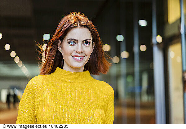 Portrait of smiling redheaded businesswoman