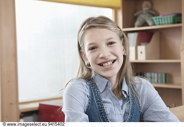 Portrait of smiling schoolgirl with laptop