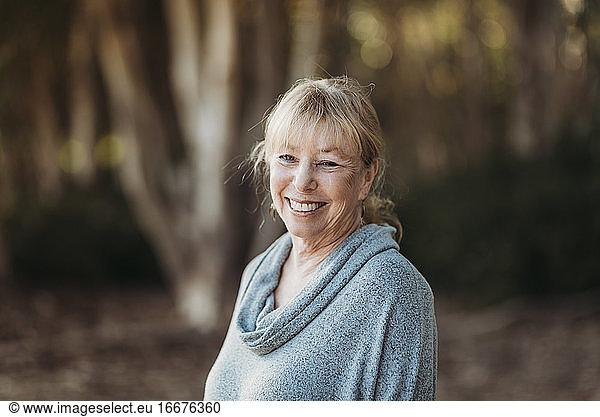 Portrait of Smiling Senior Adult Woman Smiling in Forest