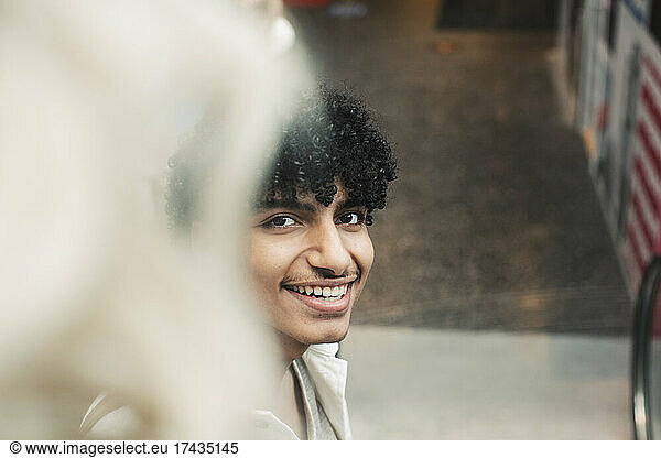 Portrait of smiling teenager boy in shopping mall